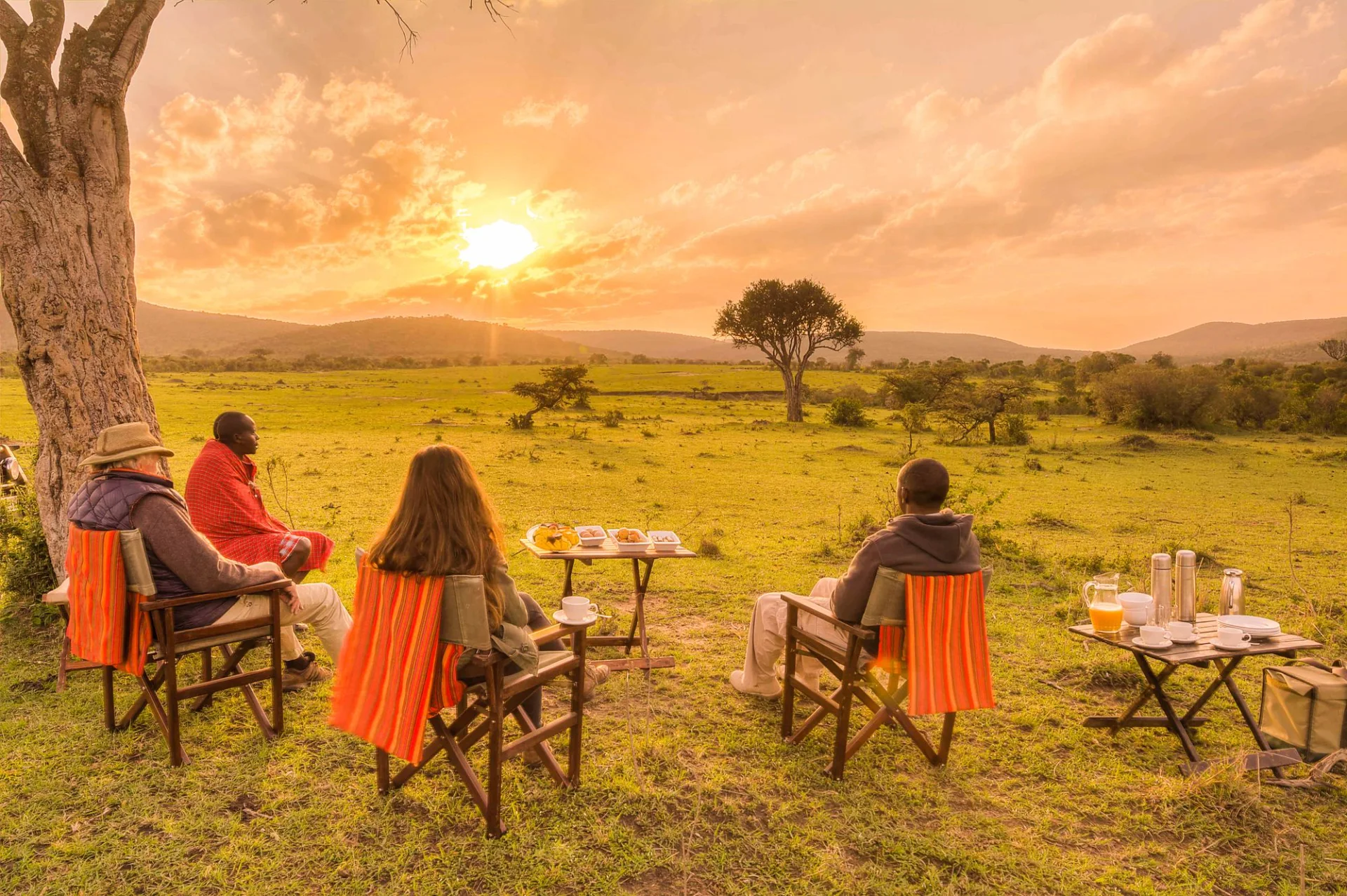 Travellers sharing a meal overlooking the Kenyan savanna